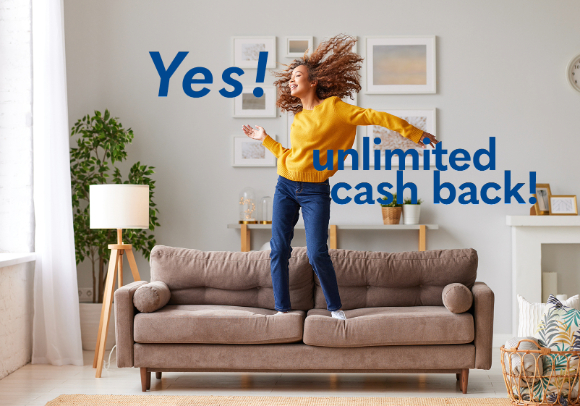 Happy woman jumping on a couch in a cozy living room, with the text 'Yes! unlimited cash back!' overlaid in bold blue letters.
